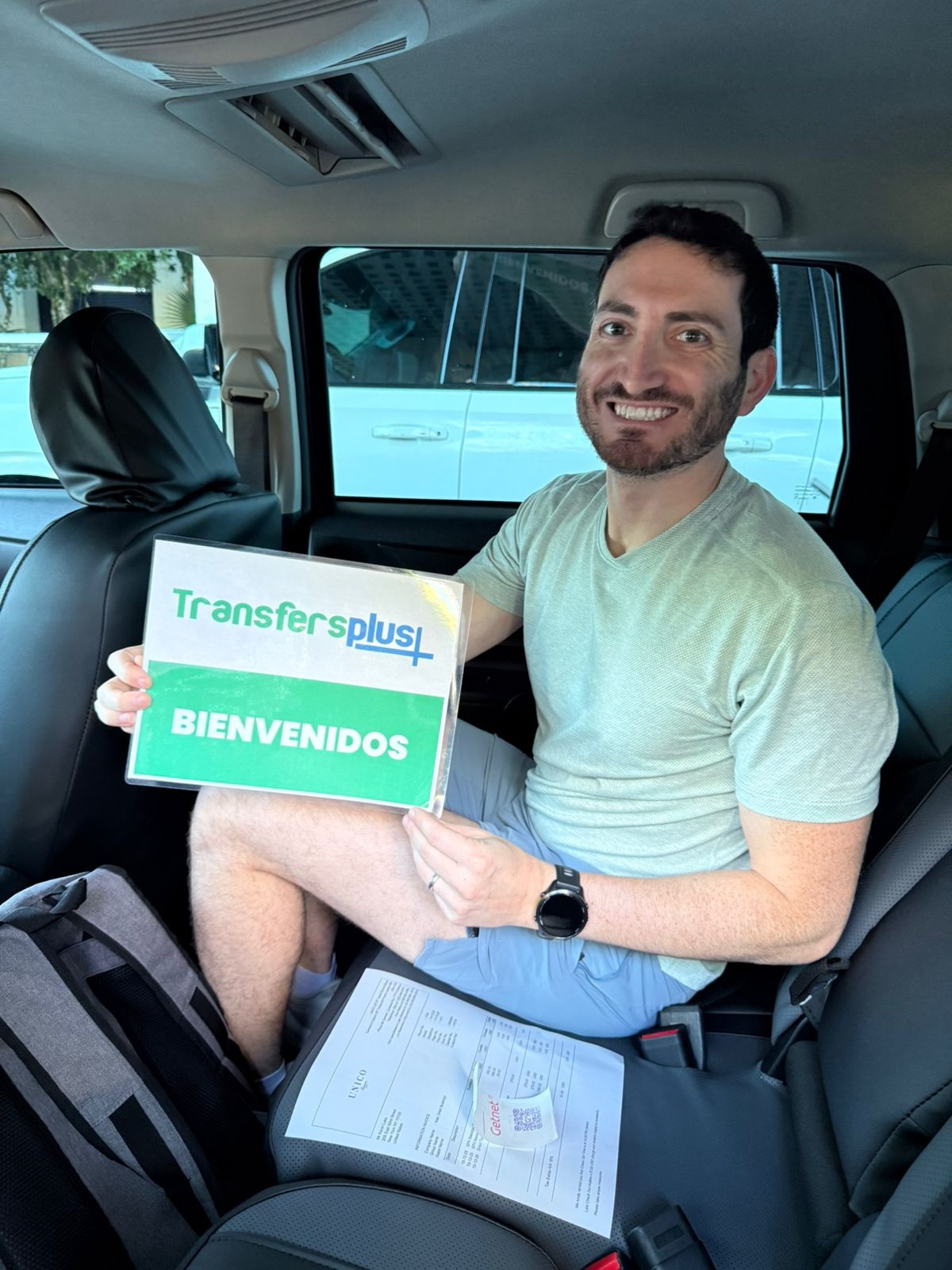 Passenger inside a private Transfers Plus vehicle after pickup at Cancun Airport